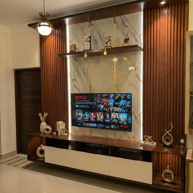 Elevate your living space with this stunning 9ft wide and 9ft high wall-mounted TV console, designed for both elegance and functionality. Featuring a luxurious combination of dark wood tones, vertical fluted panels, and a marble-effect back panel with gold accents, this unit adds a premium touch to any interior. Integrated ambient LED lighting highlights the textures and creates a cozy atmosphere. The spacious bottom unit includes sleek white cabinets for concealed storage and open shelves for electronics. Ideal for modern homes, this console is a perfect blend of style and practicality.